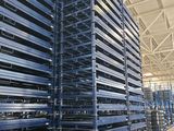 a large amount of pallets are stacked up in a warehouse