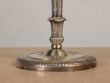 a silver candle holder on a table with a white background