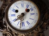 a clock with roman numerals on the face of it
