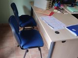 a desk with a chair and a computer on it