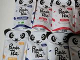 a pile of panda tea bags sitting on top of a table