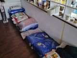 many bags of food sitting on the floor in a store
