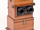 a small wooden box with two binoculars on top of it