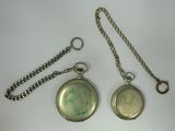 two different types of pocket watches on the table