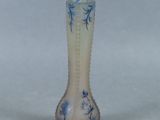 a glass vase that has a blue and white design on it