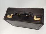 briefcase on a white background with a black handle and gold hardware