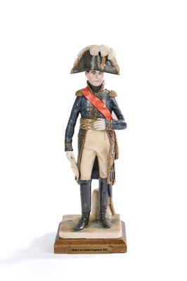 figurine of a man in a military uniform with a red sash and a hat