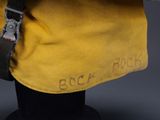 an image of a yellow backpack with a black strap on a mannequin head