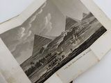 an open book with a picture of a mountain in the background