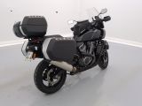 a motorcycle parked in a room with a white wall