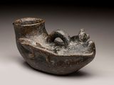 a small vase that has a handle on it