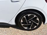 a white car with a black rim parked in a parking lot