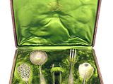 a green case with silverware in it on a white background
