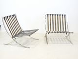 pair of chrome steel lounge chairs in the style of mies van dervoen