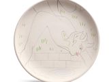 a white plate with a drawing of a cow on it