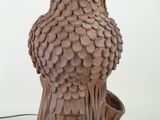 an image of a lamp with a bird on it ' s head