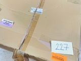 a man standing next to a pallet with a box on it