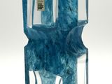 a blue glass vase with a water dispenser inside of it