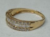 an image of a gold ring with baguets of diamonds