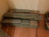 a pile of wood sitting on the floor in a room