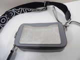 a purse that is sitting on a table with a strap around it