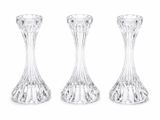 three clear glass vases sitting next to each other on a white surface