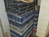 crates stacked on top of each other in a room next to a wall