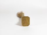 a close up of a pair of gold stud earrings sitting on top of a white surface