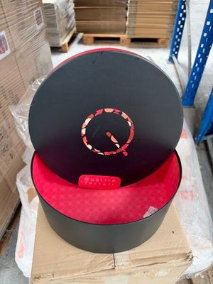 a black hat with a red circle on top of it