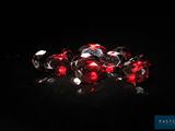 a bunch of red diamonds on a black surface
