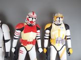 three star wars action figures standing next to each other