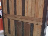 a wooden cabinet with a wooden door on top of it