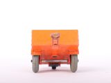 an orange toy truck that is sitting on a white surface