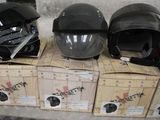 three helmets sitting on top of boxes on a table