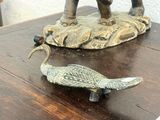 a statue of an elephant and a bird on a table