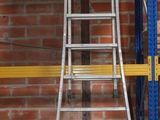 a ladder that is leaning against a wall in a warehouse
