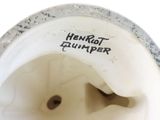 a close up of a white vase with a black and white label on it