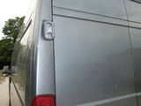 a silver van that is parked on the side of the road
