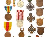 an assortment of medals and medals are displayed on a white surface