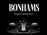 a black and white photo of a racing car with the words bonhams