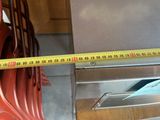 a measuring tape that is on the side of a stove