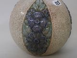 a small vase with a design on the outside of it