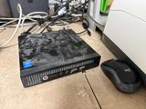 a computer sitting on the floor next to a mouse