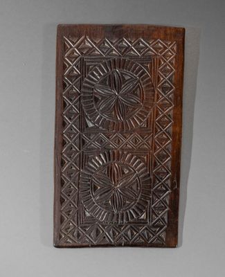 an old wooden plaque with a decorative design on it