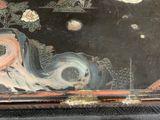 a black box with a painting on it that is sitting on a table