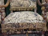 a chair with a floral upholstered seat and a wooden frame