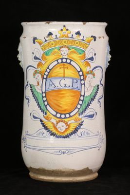a white vase with a blue and yellow design on it