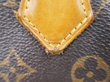 the inside of a louis vuitton bag with a yellow stitching