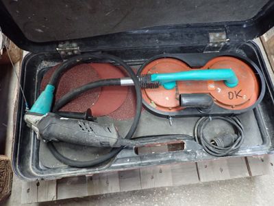 a tool in a tool box that is sitting on the floor