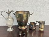 an image of a table with silverware and a vase on it